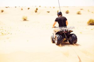 tourist riding a quad bike in the desert
