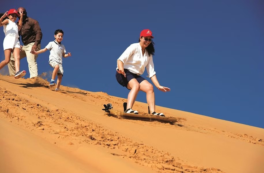 Sand boarding activity in Dubai Morning Desert Safari Tour